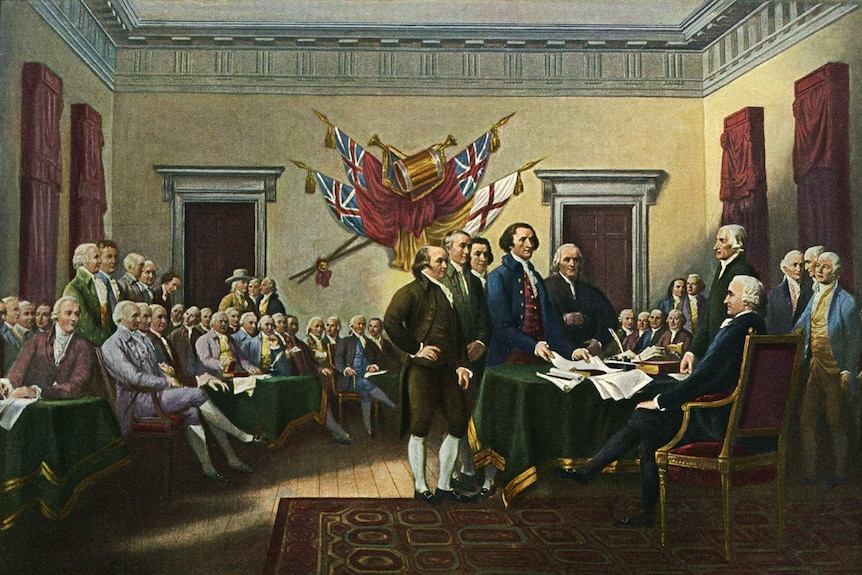 A painting of men gathering around a desk upon which sits the declaration of independence. Other men sit and look on