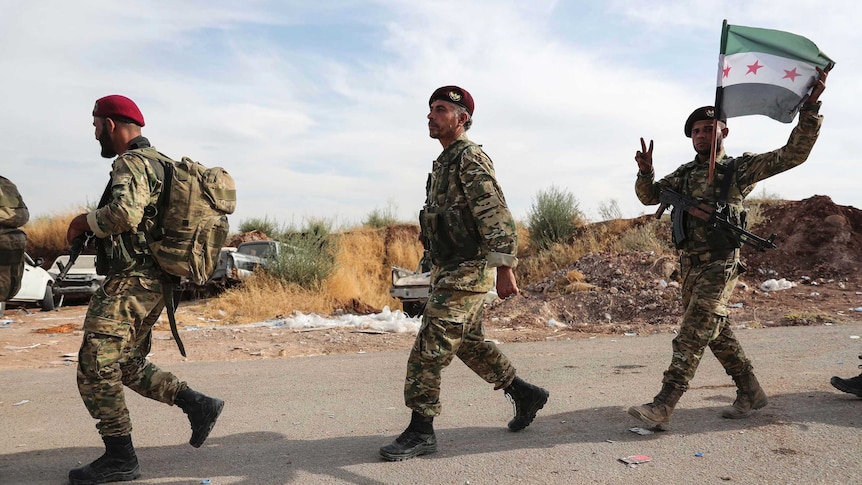 Syrian Kurdish fighters of Turkey-backed Free Syrian Army enter Turkey from Syria.