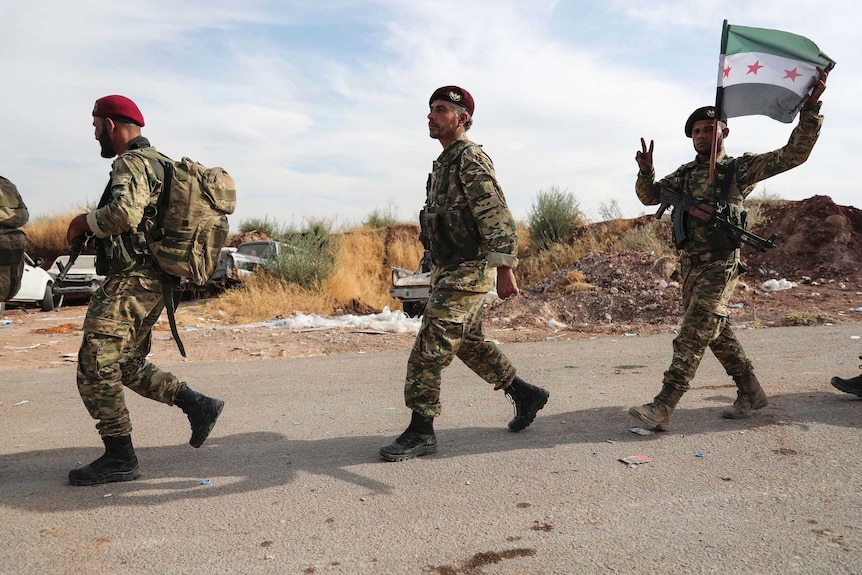 Syrian Kurdish fighters of Turkey-backed Free Syrian Army enter Turkey from Syria.