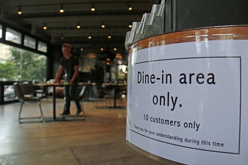 A sign in a restaurant advises patrons of a 10-person limit during the coronavirus pandemic.
