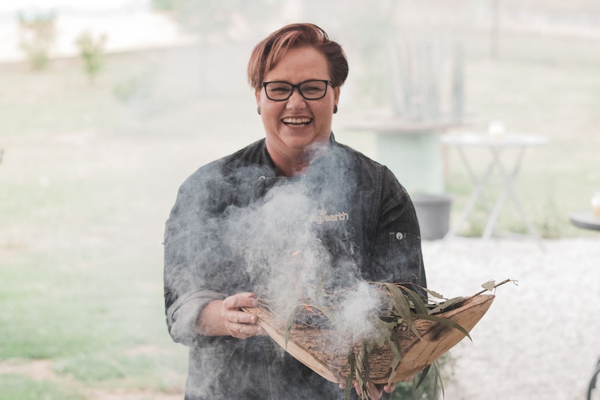 Sharon Winsor, founder of Indigiearth, smiling and holding a basket of native ingredients.