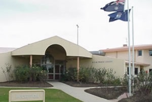 Victoria's state flag and Australia's flag fly outside Loddon Prison.