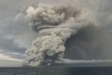 A volcano erupts out of the sea.