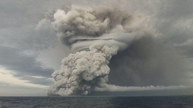 A volcano erupts out of the sea.