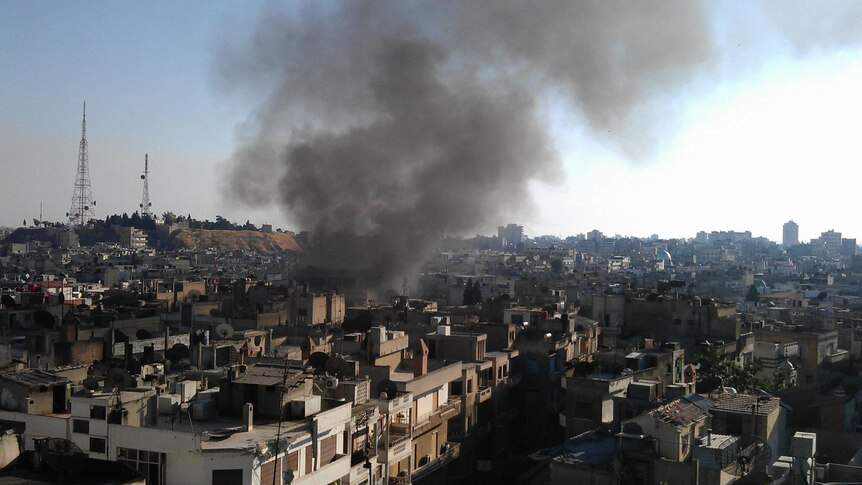 Smoke rises after shelling in the restive city of Homs.