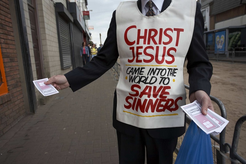 Christian religious fundamentalist handing out leaflets in the main street at the ballyclare may fair
