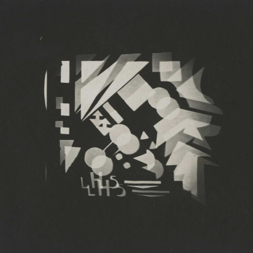 A slide of black and white projections of a pattern of geometric shapes