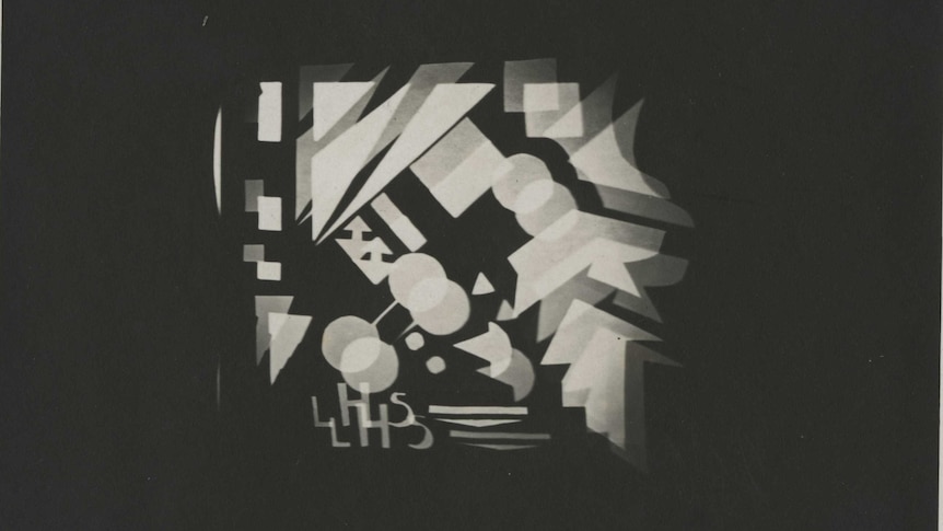 A slide of black and white projections of a pattern of geometric shapes