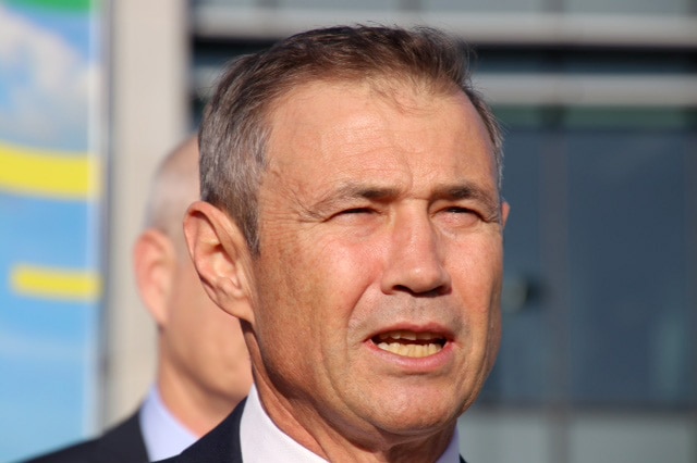A head shot of Roger Cook speaking to journalists at the site of the planned medihotel.