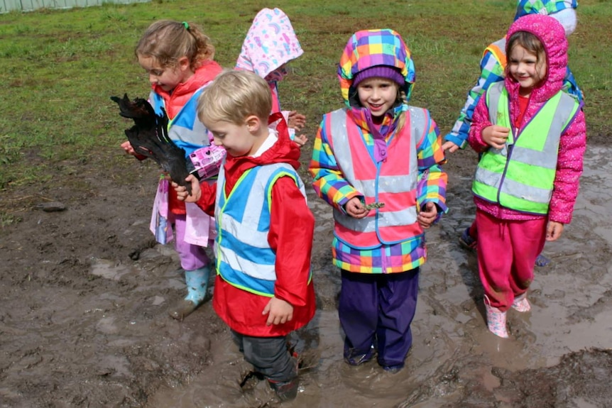 Chapman Primary School kindergarten students playing in the mud.