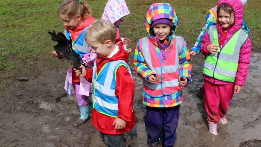 Chapman Primary School kindergarten students playing in the mud.