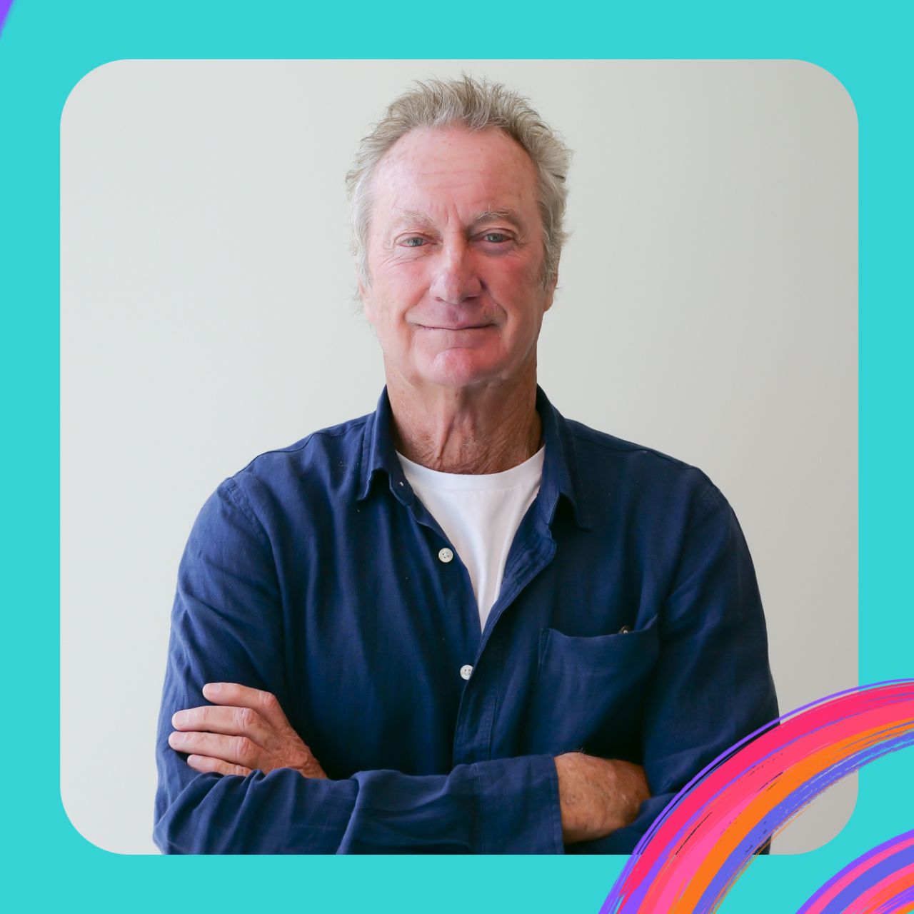 Bryan Brown stands with arms crossed, smiling.