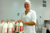 A worker bottles milk at Red Cow Dairy