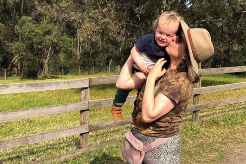 Alexandra and her son outside at a farm