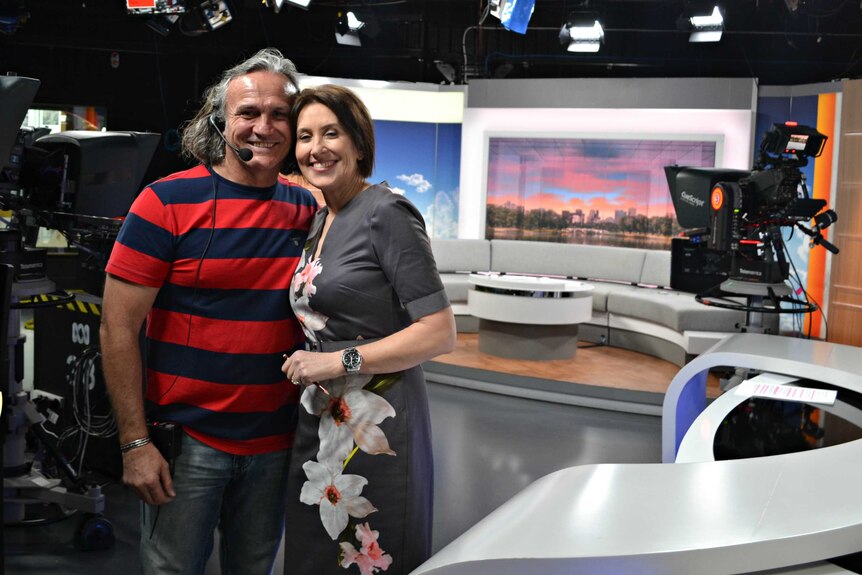 ABC presenter Virginia Trioli and floor manager Joe Sumic hug on set.