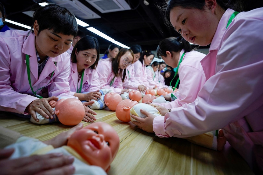 A group of Chinese women learning nursing skills