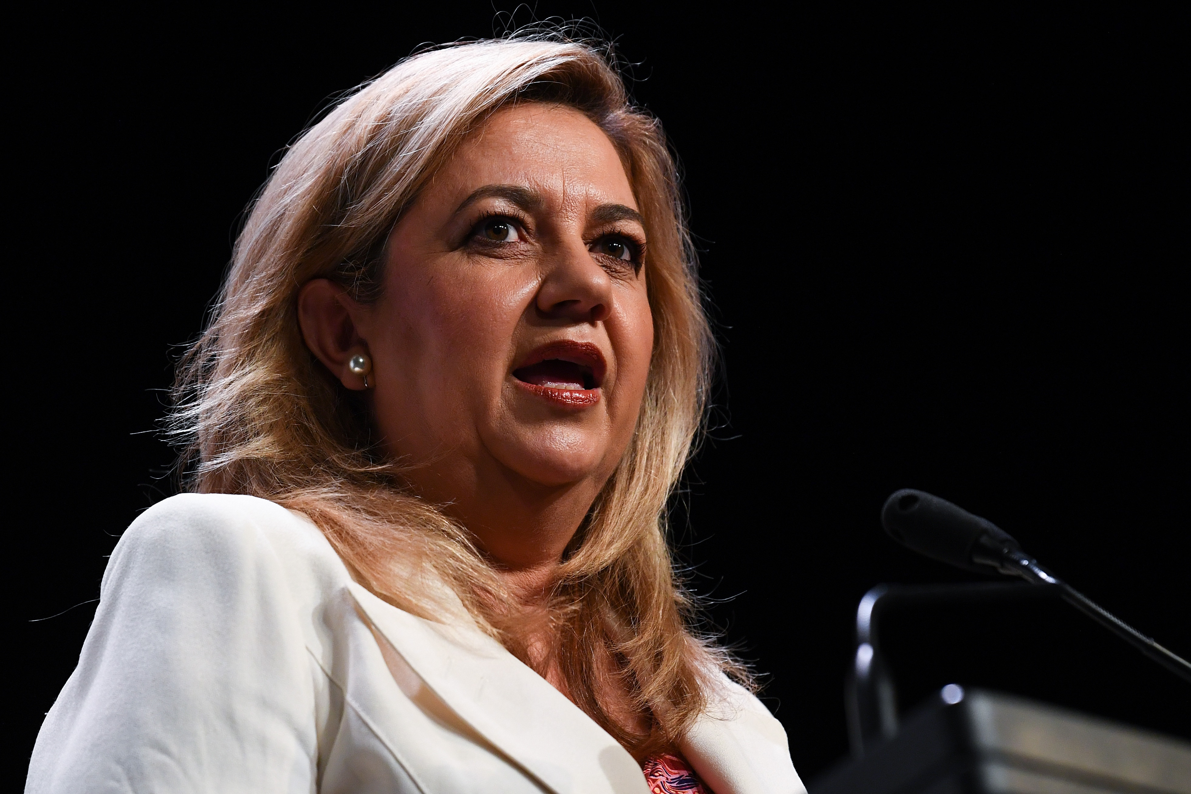 the premier speaking behind a lecturn 