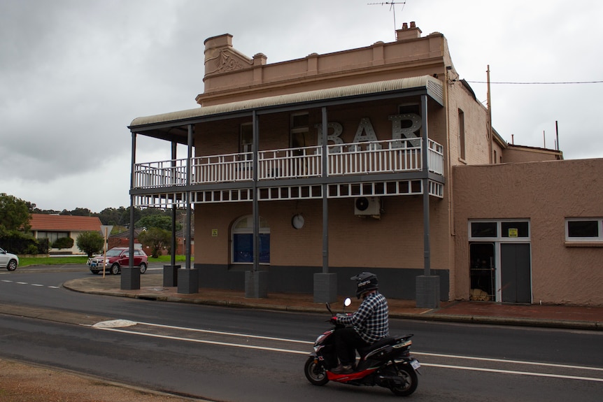 A scooter passes by Club Hotel Collie.