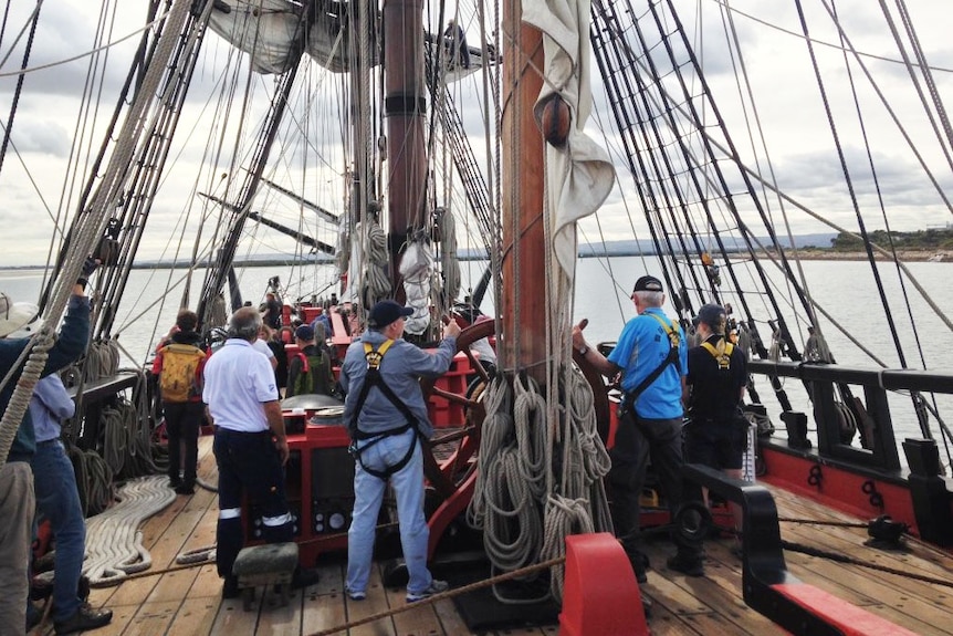 People on board the replica Endeavour as it sails into Port Adelaide