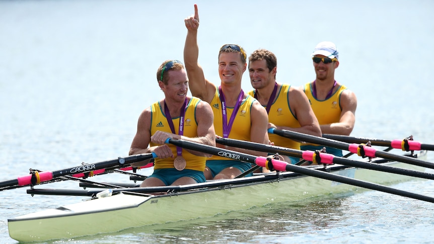 Daniel Noonan, James Mcrae, Karsten Forsterling and Christopher Morgan celebrate in their boat with their bronze medals.