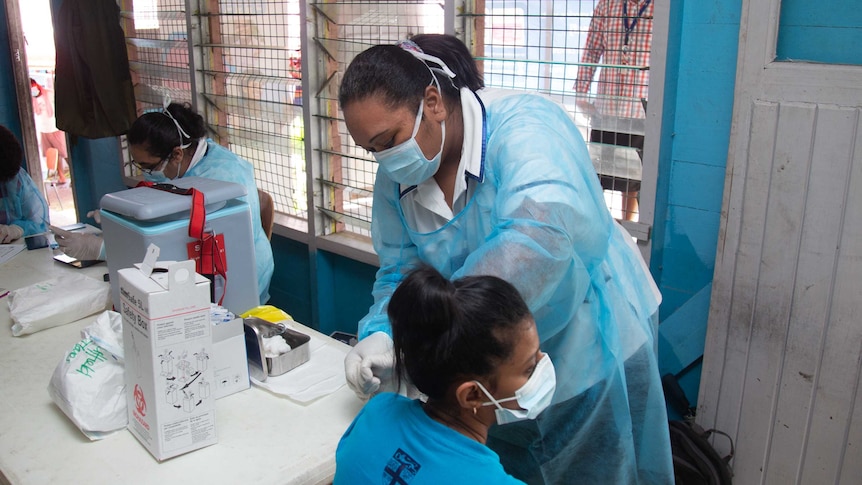 A woman is vaccinated against COVID-19 in Fiji.