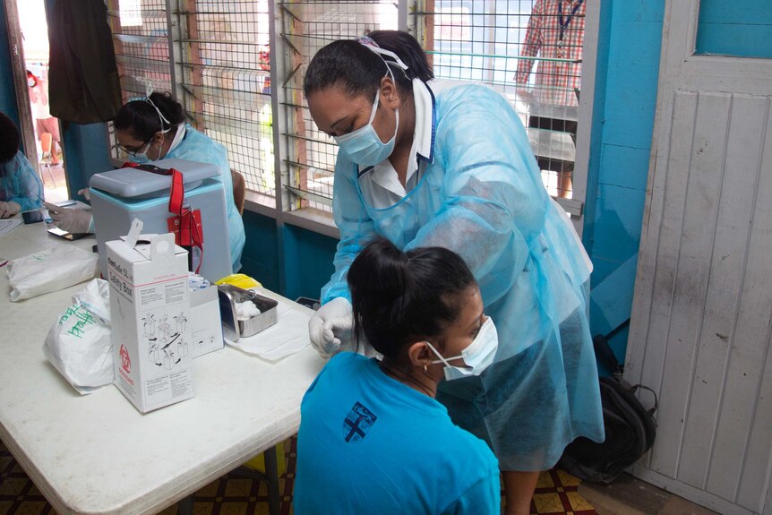 A woman is vaccinated against COVID-19 in Fiji.