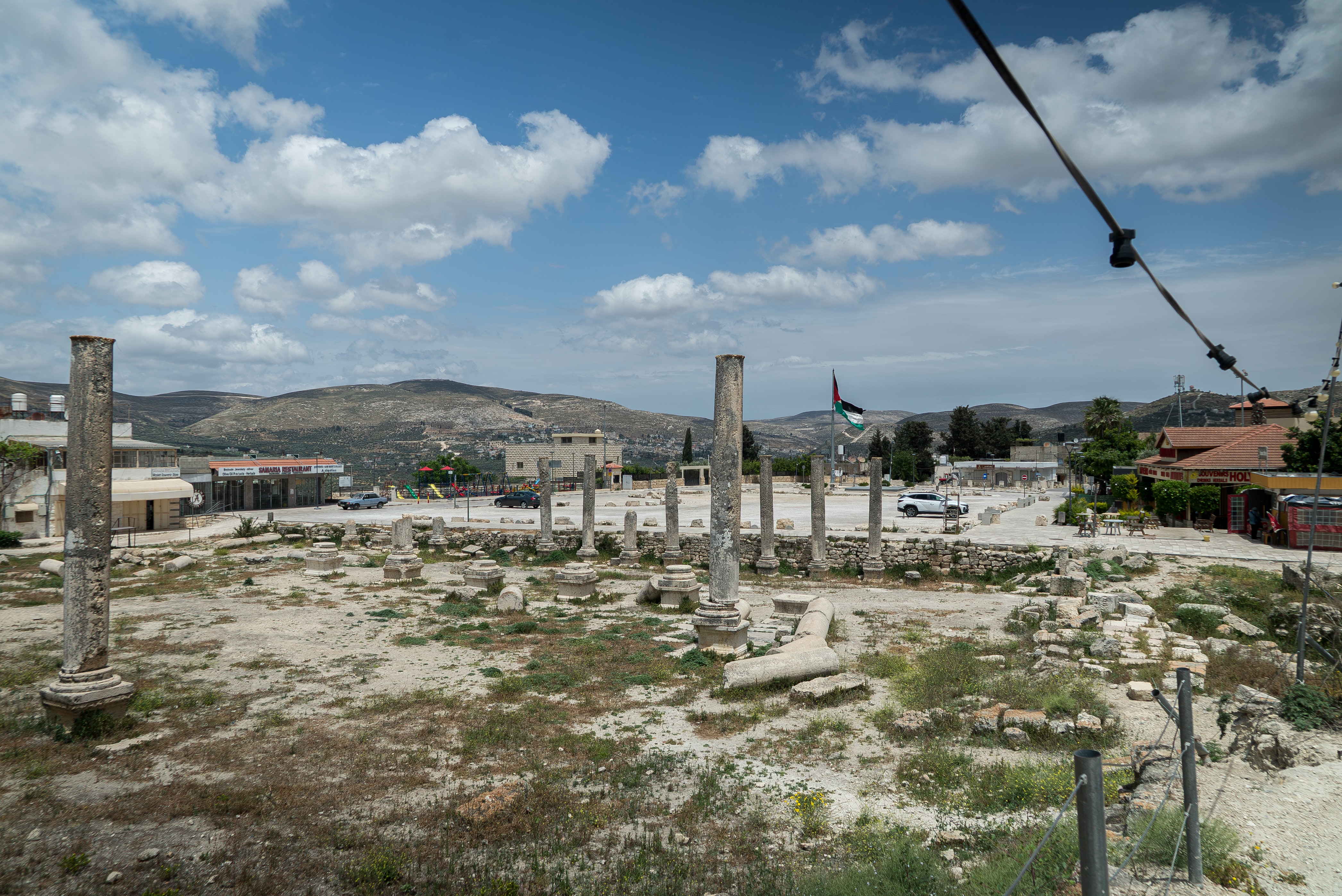 A close up of ancient ruins surrounded by patchy grass.