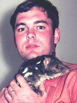 man holding quoll