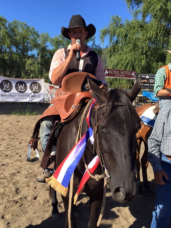 King of the Ranges, Bronson Macklinshawsititng on his horse as he holds a microphone