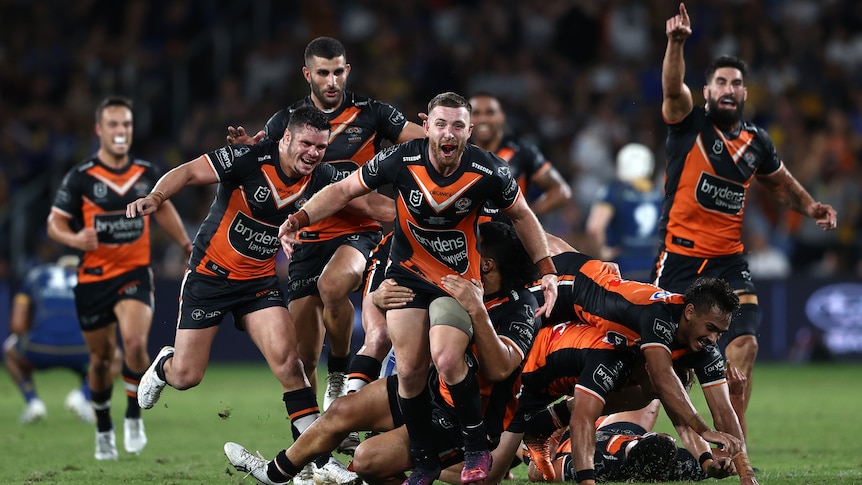 A group of NRL players celebrate a field goal
