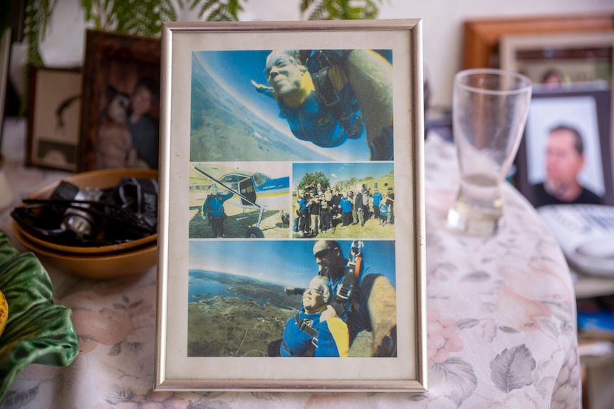 a picture frame on a table of an elderly woman skydiving 