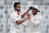 Shakib Al Hasan gets a pat on the back from teammate Sabbir Rahman.