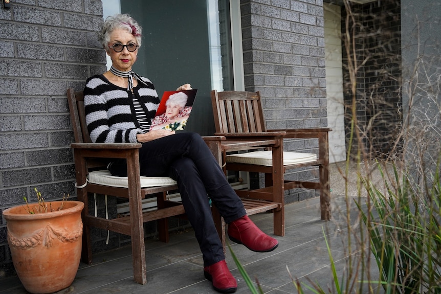 Peta Soorkia holds a photo of her mother on her front porch.