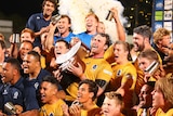 Winners are grinners ... Brisbane City captain Dave McDuling holds up the NRC trophy