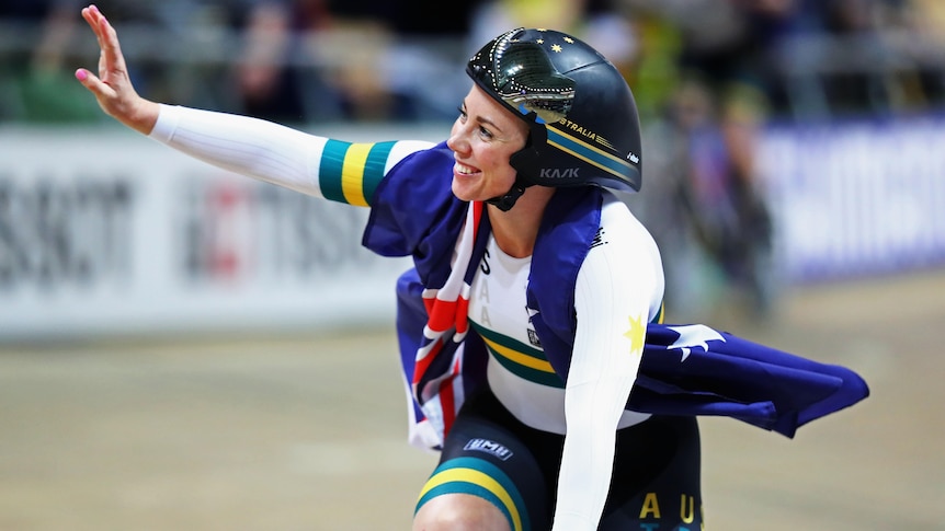 An Australian female track cyclists waves to the crowd at the 2019 world championships.