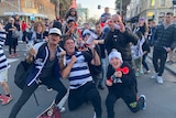 Football fans celebrating in a city street.