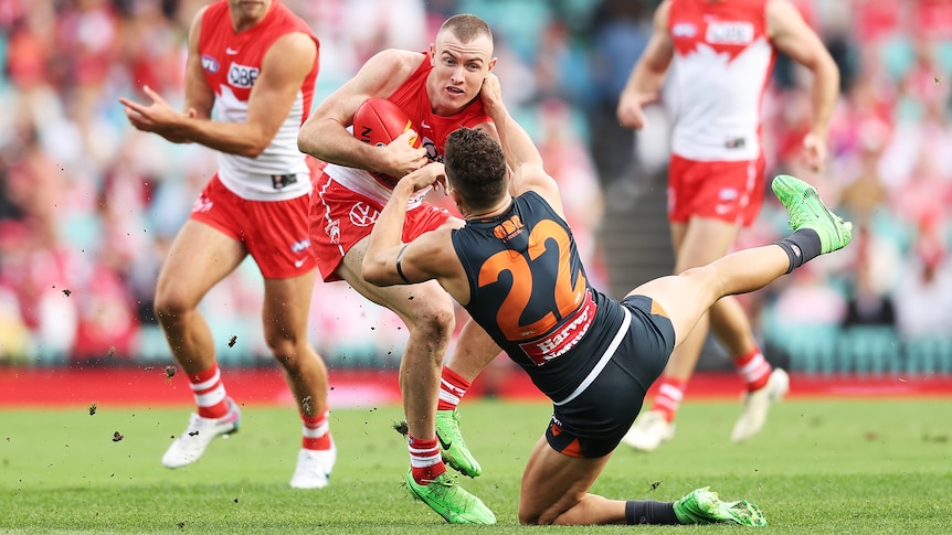 Chad Warner pushes Josh Kelly off in a tackle
