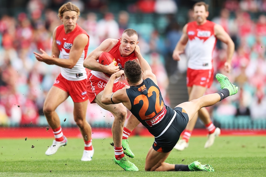 Chad Warner pushes Josh Kelly off in a tackle