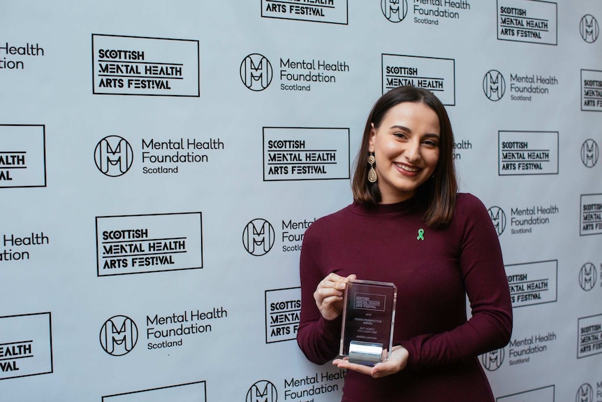 Jennifer Leonforte holds the award she won at the 2018 Scottish Mental Health Arts Festival.