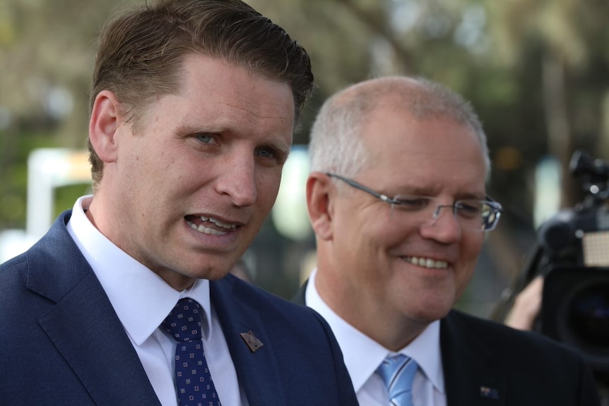 Scott Morrison smiles as Andrew Hastie responds to a question at a press conference