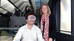 HMRI's Amy Anderson and research assistant Luke Duffy demonstrating the use of 'beer goggles'.