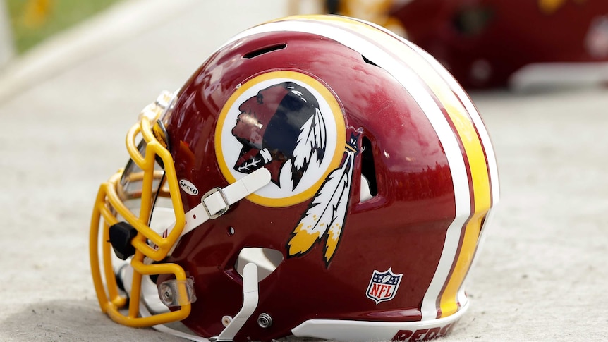 A Washington Redskins helmet lies on the ground