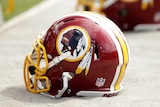 A Washington Redskins helmet lies on the ground