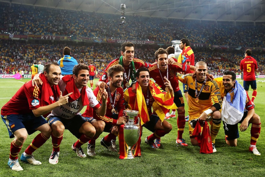 Spanish players pose with the trophy after Spain's victory in the Euro 2012 final against Italy.