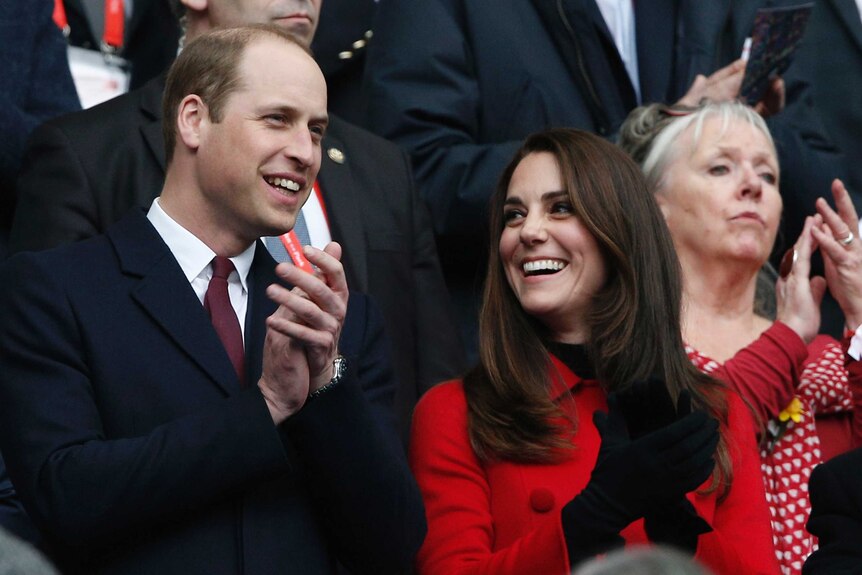Prince William and Kate Middleton watch a rugby match at the Stade de France stadium.