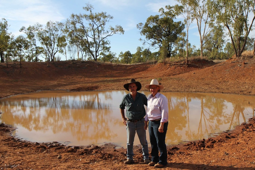 Bruce and Annette Currie stand near the only surface water on their property.