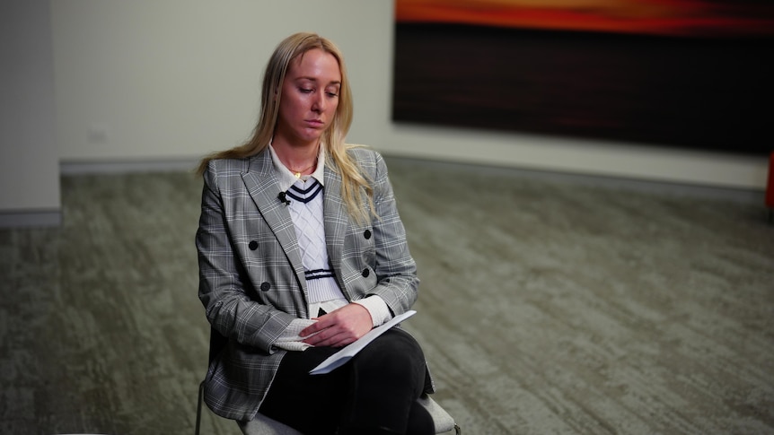 A young blonde woman named Ariel Bombara sitting while being interviewed.