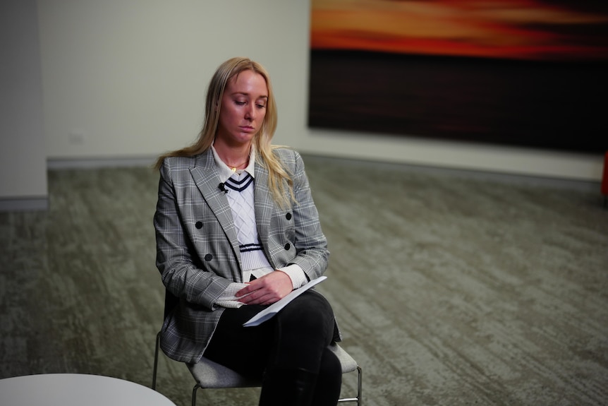 A young blonde woman named Ariel Bombara sitting while being interviewed.
