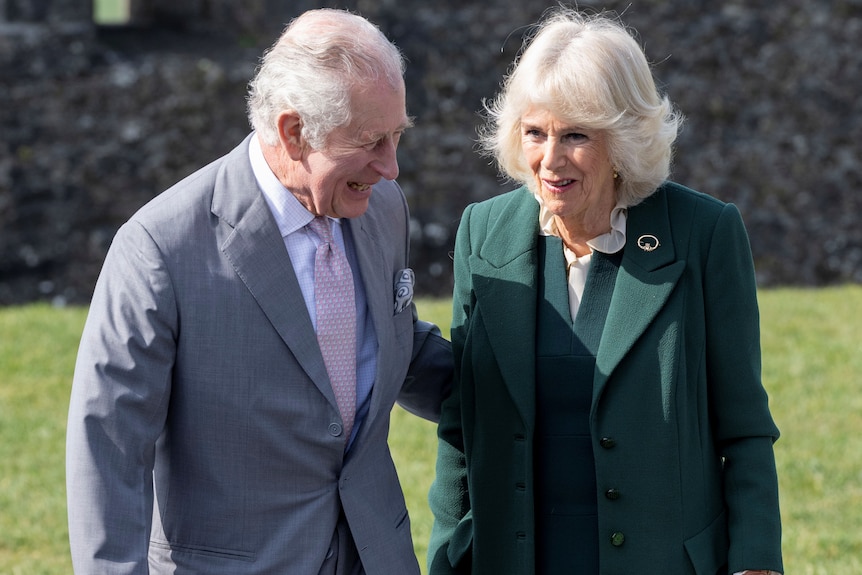 Britain's Prince Charles puts his arm around Camilla.