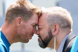 David Warner and another man perform a hongi, with their foreheads touching